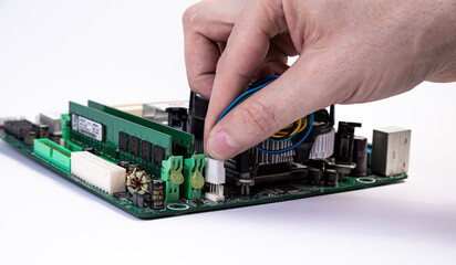 Engineer repairman holding hands in black gloves chip processor, CPU to insert into the socket of the computer motherboard. The concept of technology hardware in the neon light