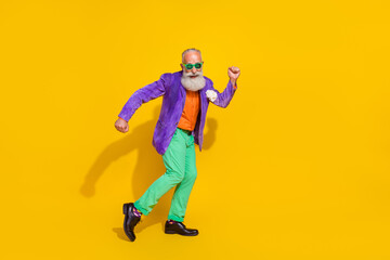 Fototapeta na wymiar Full size photo of handsome grandpa hipster good mood energetic dance dressed stylish colorful clothes isolated on yellow color background