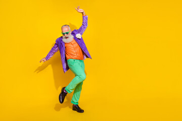 Fototapeta na wymiar Full length photo of attractive excited man wear purple velvet jacket enjoying discotheque empty space isolated yellow color background
