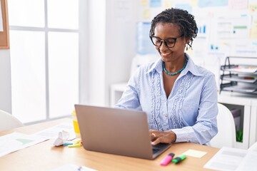 Middle age african american woman business worker using laptop working at office - Powered by Adobe