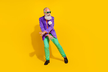 Full body photo of handsome grandparent cool dancing boogie woogie dressed stylish colorful garment isolated on yellow color background