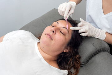 Obraz na płótnie Canvas beauty treatment on the face and beautification of eyebrows and eyelashes in a beauty salon