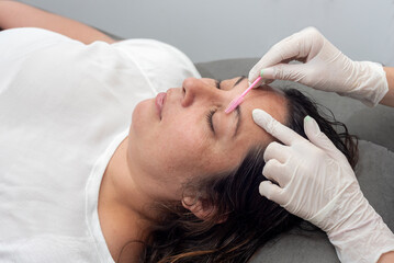 beauty treatment on the face and beautification of eyebrows and eyelashes in a beauty salon