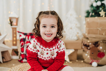smiling cute little girl at home during christmas time
