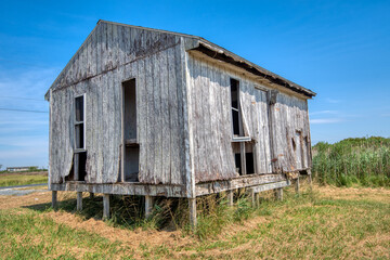 Closeup of deserted cabin in rural setting.