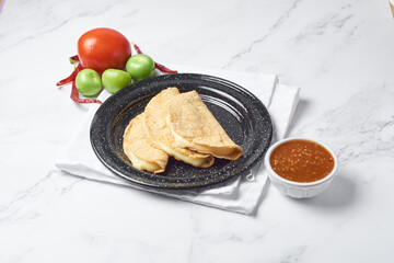 Traditional Mexican food, corn tortilla quesadillas, stuffed with cheese.