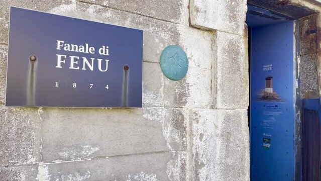 Entrance of the "Headlight of Fenu" (or Capu di Fenu) and its welcome sign on large stone bricks wall, near Bonifacio at the southern coast tip of Corsica