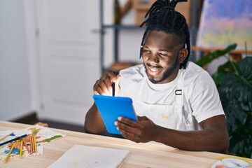 African american woman smiling confident drawing on touchpad at art studio