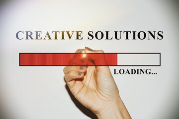 Woman hand with glitter nails showing the Loading Bar with the text “Creative solution”