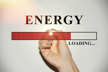 Woman hand with glitter nails showing the Loading BarWoman hand with glitter nails showing the Loading Bar with the text “Energy”