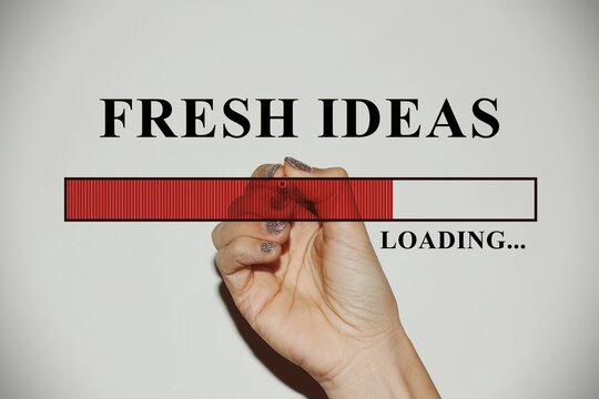 Woman hand with glitter nails showing the Loading Bar with the text “fresh ideas”