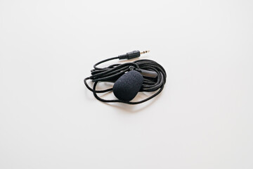 Buttonhole on a white background. Compact microphone for audio recording.