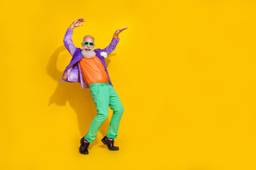 Fototapeta na wymiar Full length photo of attractive grandpa dancing boogie woogie tiptoes dressed stylish colorful outfit isolated on yellow color background