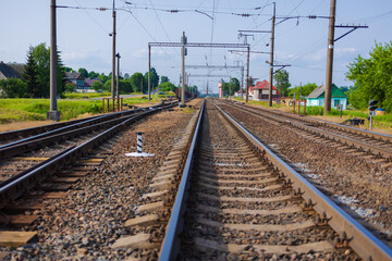 Fototapeta na wymiar Railway tracks on a summer day and a view of the station