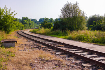 Railway tracks on a summer day and a view of the station