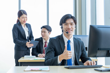 A group of young Asian businessmen Talking and planning work happily and have fun. at the company's office