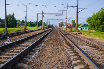 Railway tracks on a summer day and a view of the station