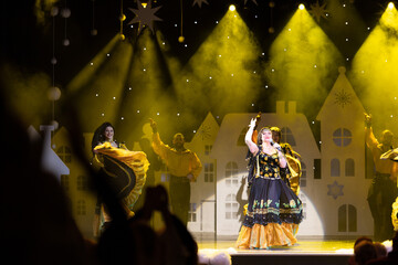 Musicians, singers and dancers in gypsy costumes singing and dancing on stage