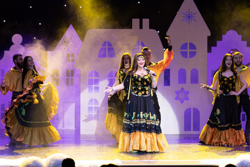 Musicians, singers and dancers in gypsy costumes singing and dancing on stage