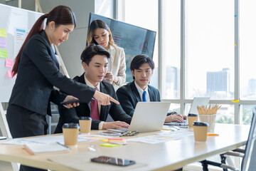 A group of young Asian businessmen Talking and planning work happily and have fun. at the company's office