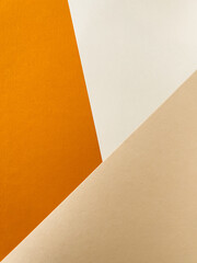 Abstract colourful paper background on office table with texture. White, beige, orange