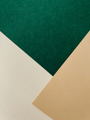 Abstract colourful paper background on office table with texture. Green, beige, white