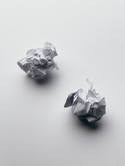 Two rumpled paper balls isolated on a white background