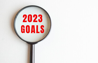 2023 GOALS text written on gray background. We read it through a magnifying glass.