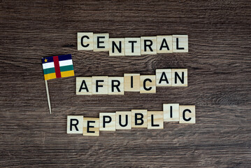Obraz premium Central African Republic - wooden word with CAR flag (wooden letters, wooden sign)