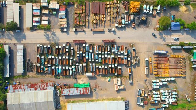 Drones are flying over truck parking lots, trucks containers with truck trailers. transportation and business industry. Import and export concept. tropical in southeast asia. aerial view. 4K footage
