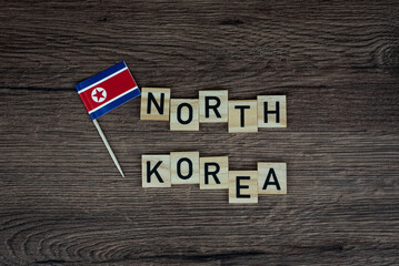 North Korea - wooden word with north korean flag (wooden letters, wooden sign)