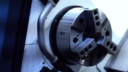 Close up of rotating fast metal detail. Motion. Spinning part of an industrial machine at the workshop.