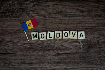 Fototapeta na wymiar Moldova - wooden word with moldovan flag (wooden letters, wooden sign)