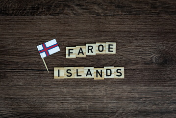 Fototapeta na wymiar Faroe Islands - wooden word with faroe islands flag (wooden letters, wooden sign)