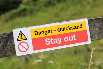 A warning sign saying 'Danger - Quicksand', 'Stay Out', England, UK