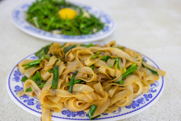 Taiwanese local food with fry vegetable and flat rice noodle