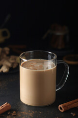 A cup with masala chai in low key