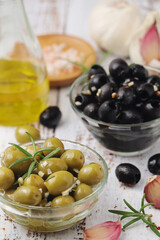 Black and green olives in glass bowls