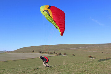 Paragliders launching from on a hill	