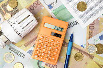 Thermostatic Valve Head, Calculator on Euro Banknotes Background. Increasing Consumption. Cost of...