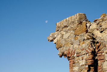 The ruins of an old castle with moon in the sky