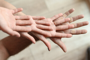 close-up of a couple holding hands, a family expressing sympathy and understanding, close-up of a Caucasian man's hands.