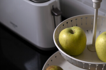 apple in fruit bowl on kitchen counter
