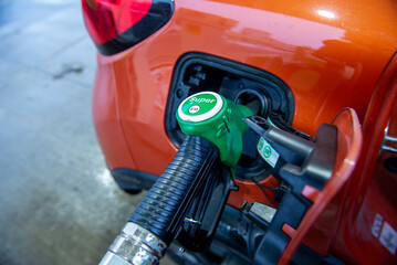 Close up of car filling up the tank with e10 gasoline