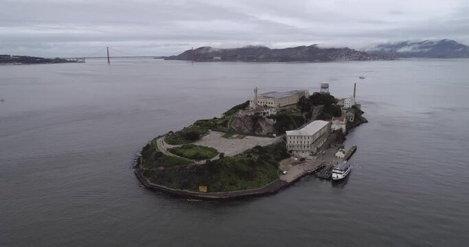 Aerial view of Alcatraz island in the San Francisco Bay. USA. The most famous Alcatraz Prison, Jail. Sightseeing Place. Tourists Ferry in Foreground 