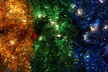 Fototapeta premium Blue, green and yellow Christmas garland with lights.