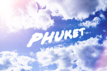 Phuket. Text from clouds in sky in bright sunlight.