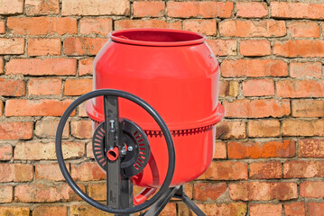 concrete mixer on the background brick wall