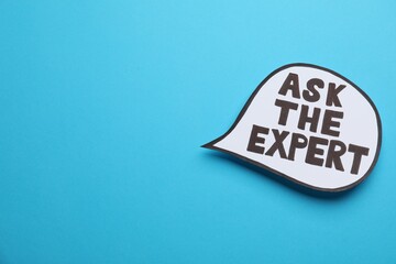 Speech bubble sticker with phrase Ask The Expert on light blue background. Space for text