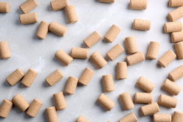 Wine bottle corks on light grey marble table, flat lay